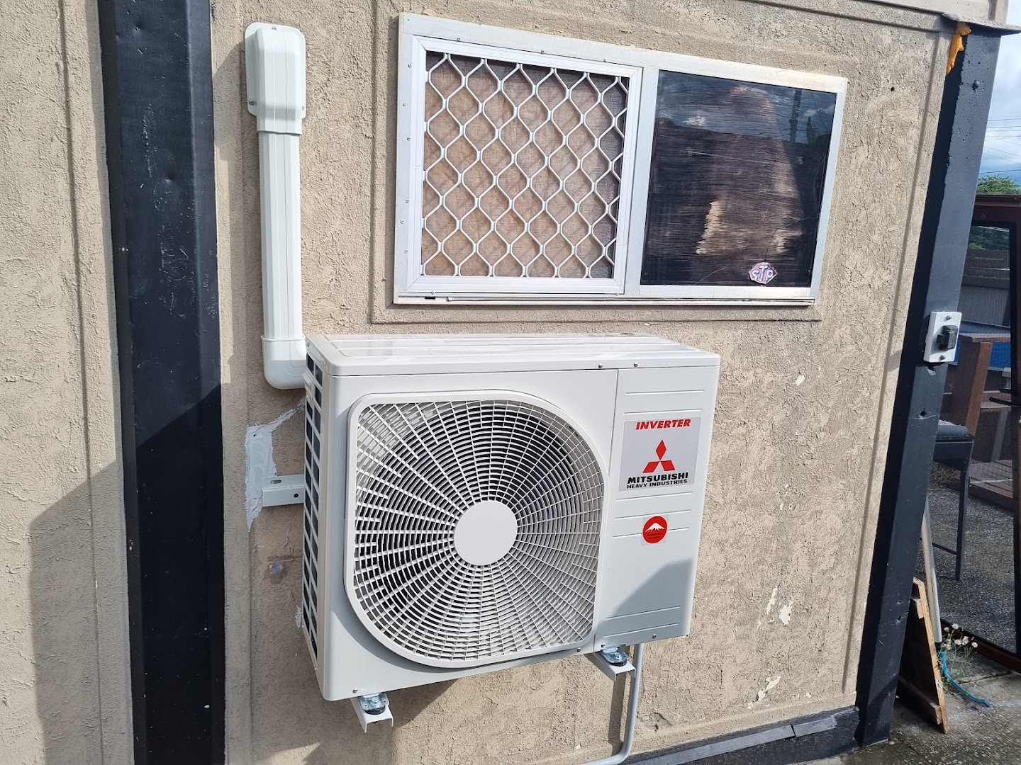 Outdoor air conditioning unit installed on a wall